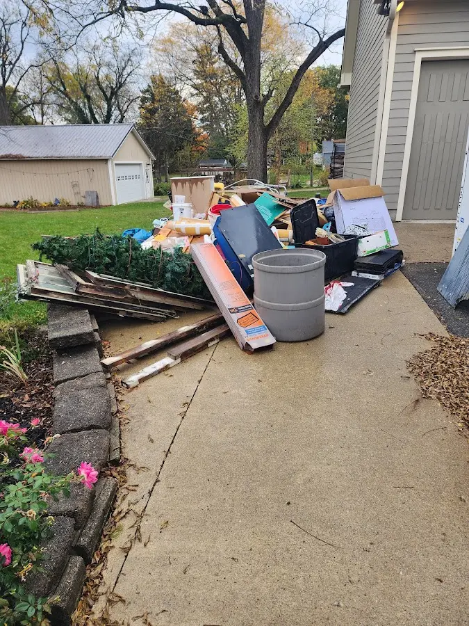 Dumpster being loaded with debris for 12 Yard Dumpster Rental in Virden